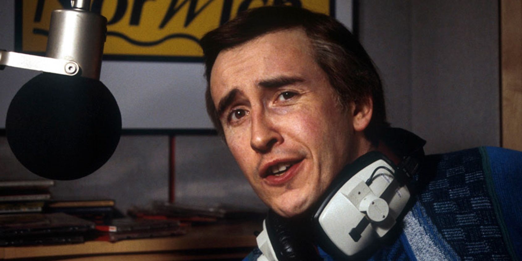Alan sitting in a recording booth in I'm Alan Partridge