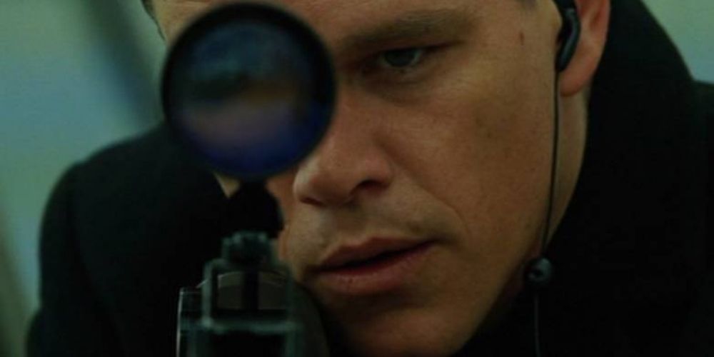 Jason Bourne prepares to fire at his target