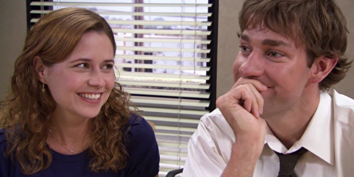 Pam and Jim giggling and smiling together on The Office