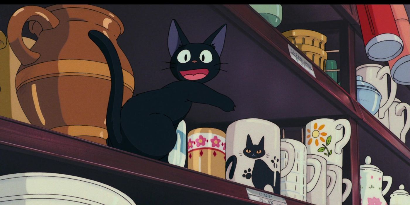Jiji points at a mug that has his likeness on in Kiki's Delivery Service