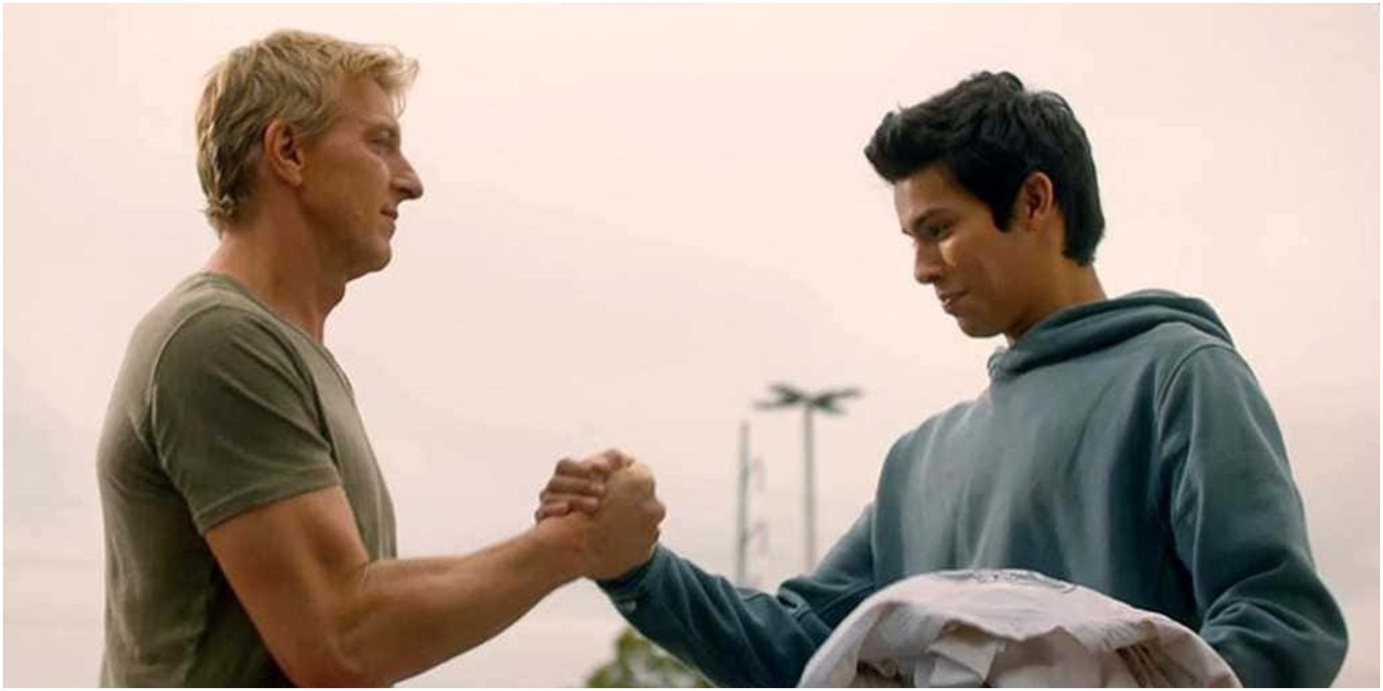 Johnny and Miguel clasping hands in Cobra Kai