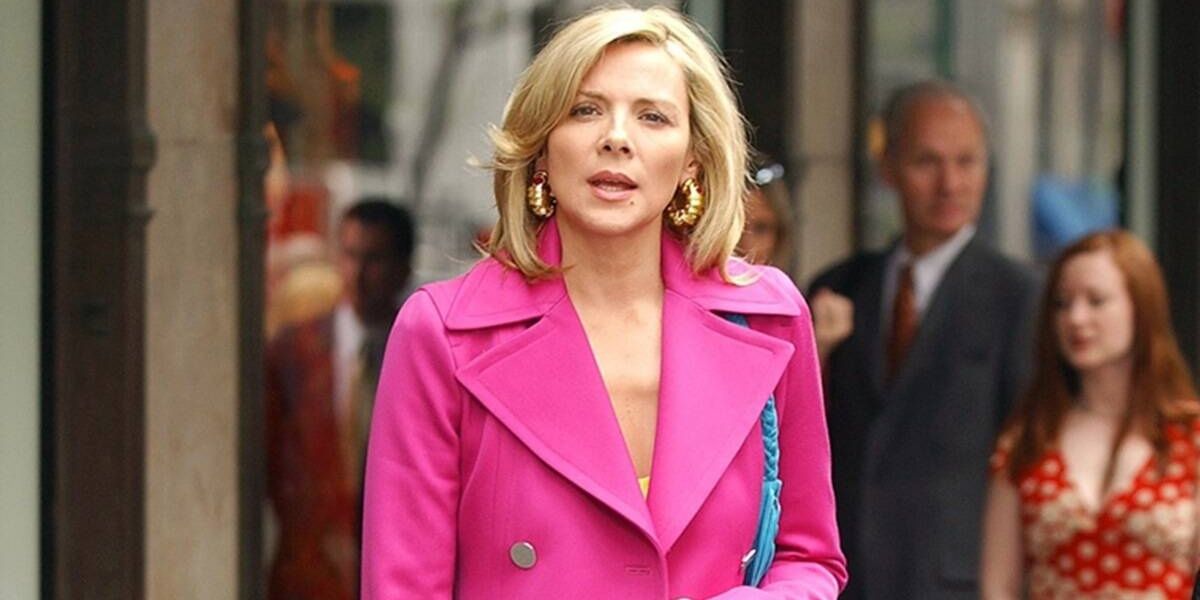 Samantha wearing a hot-pink coat while standing on the street