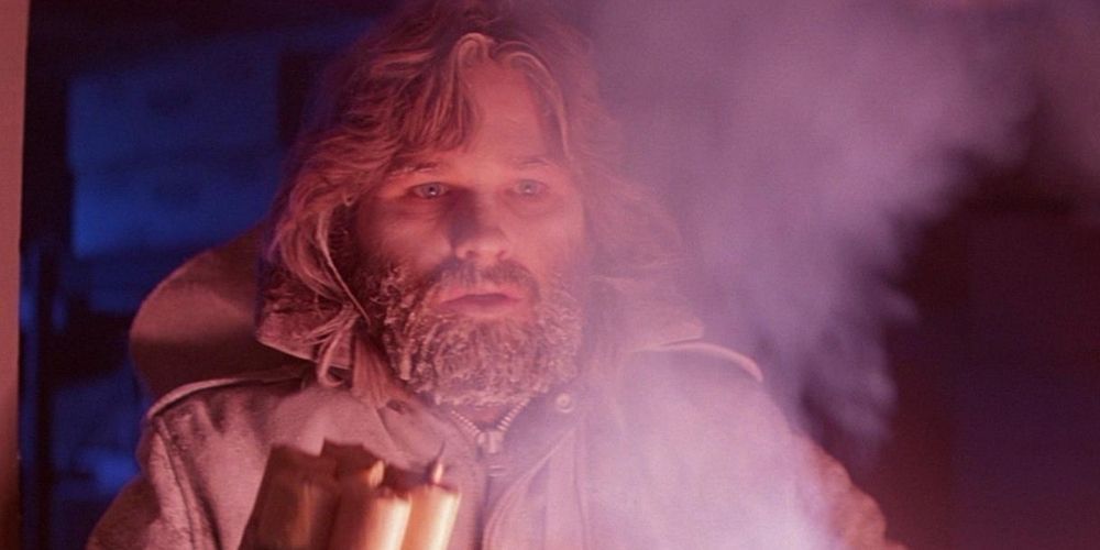 A scared MacReady looking at someone through some smoke