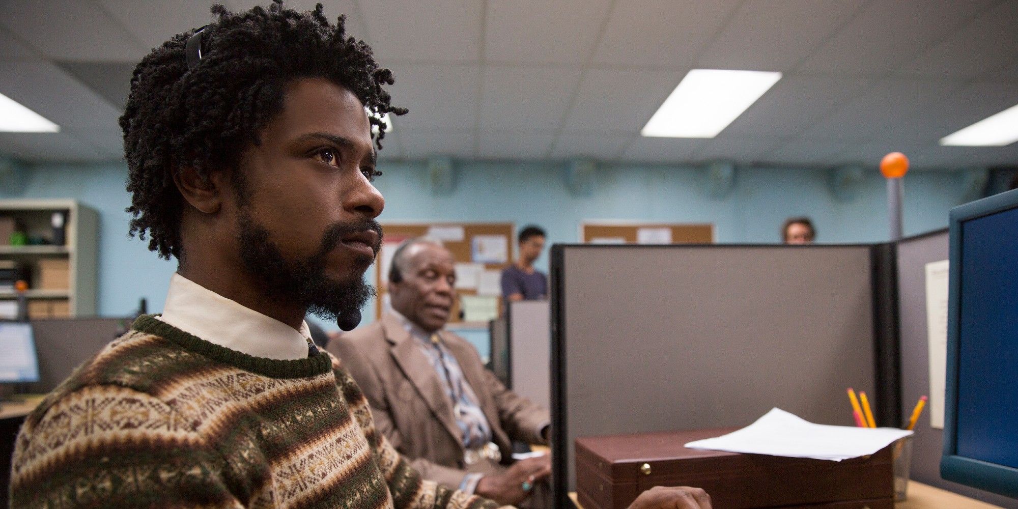 Lakeith Stanfield sitting at his computer in Sorry To Bother You