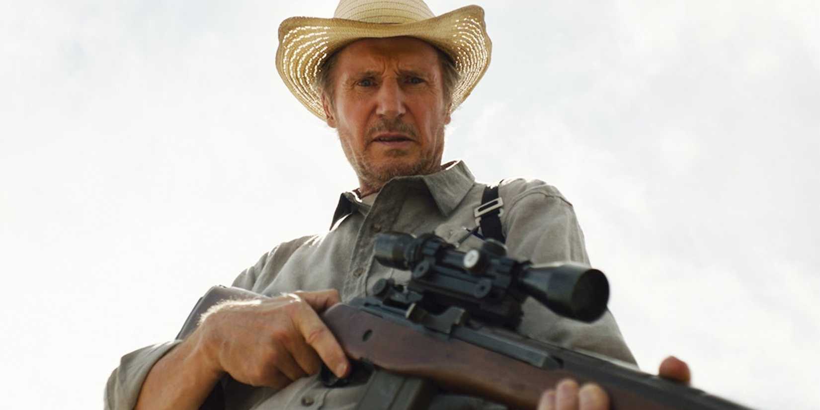 Liam Neeson as Jim Hanson in The Marksman with gun pointing down
