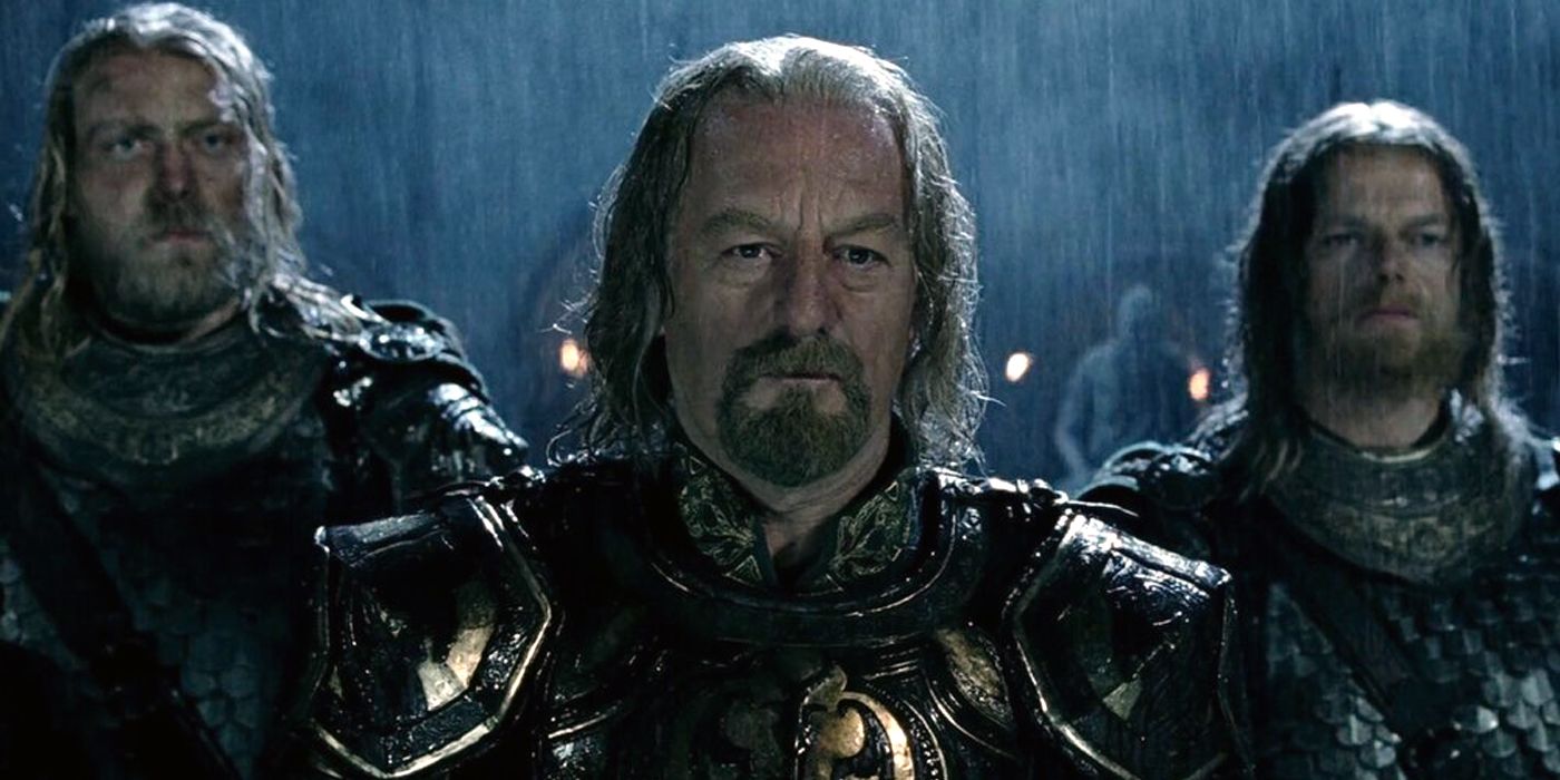 Bernard Hill as King Theoden standing with two soldiers in the rain in The Lord of the Rings: The Two Towers