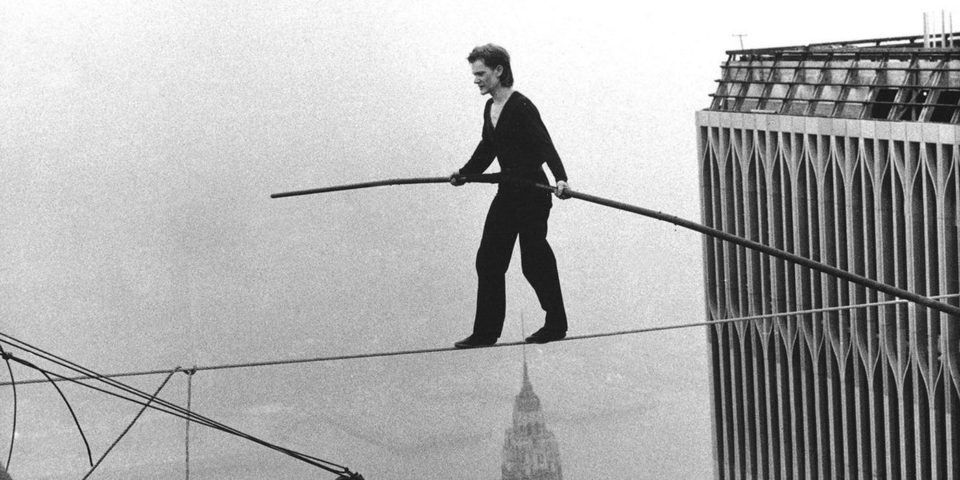 A man in a black and white image walking on a tightrope in Man On Wire
