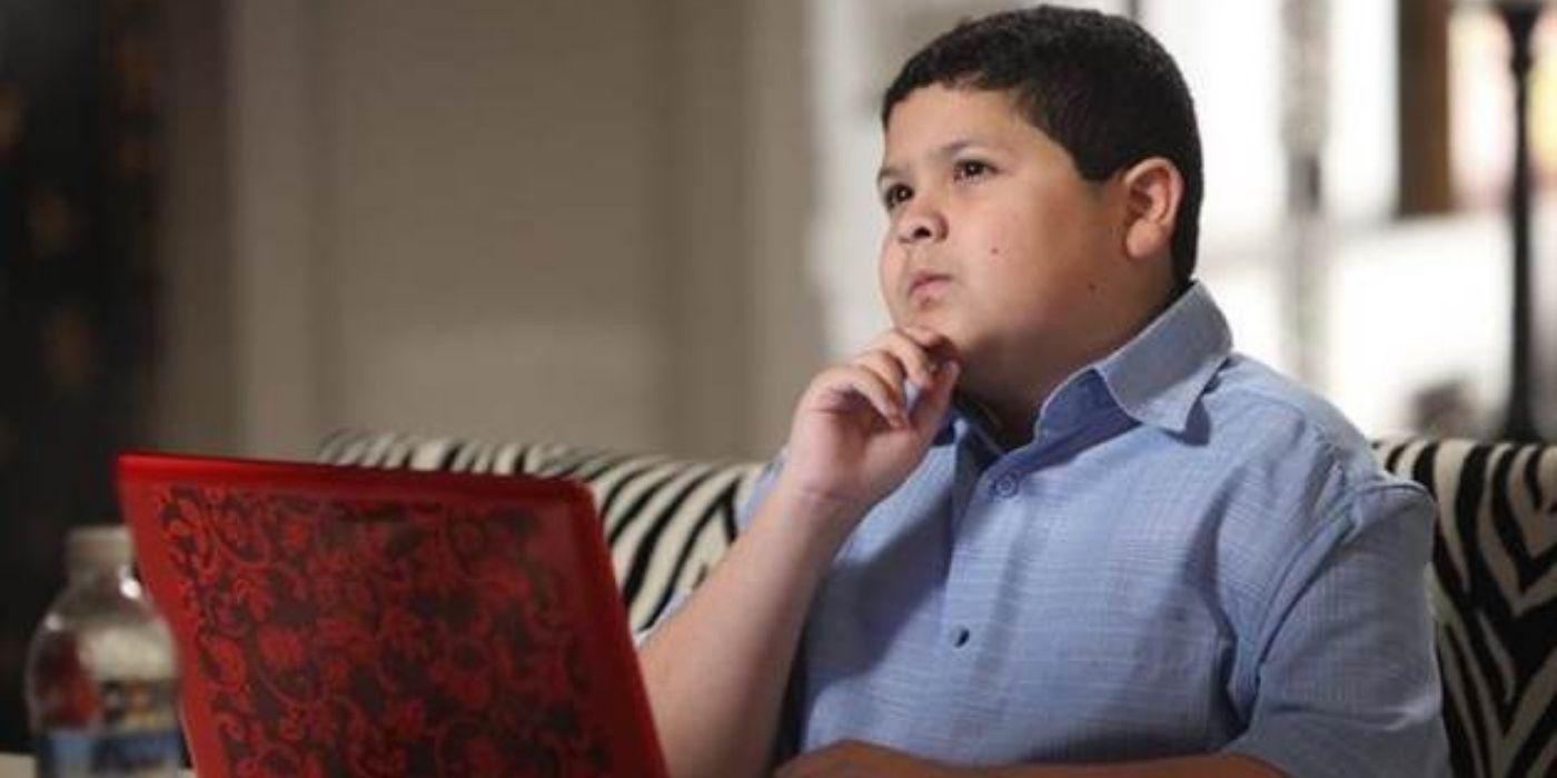 Manny sits at his laptop in Modern Family
