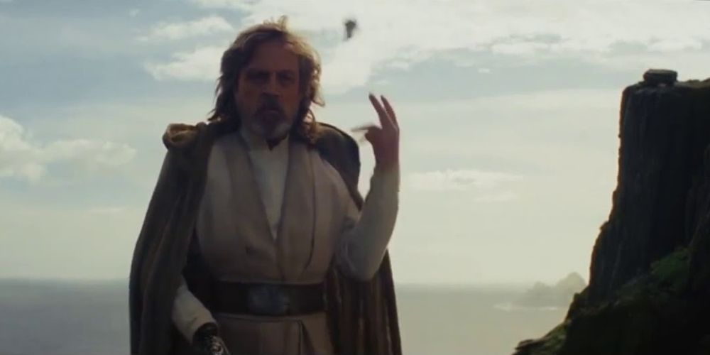 Luke Skywalker tosses his lightsaber away after Rey returns it to him on Ach-To in The Last Jedi