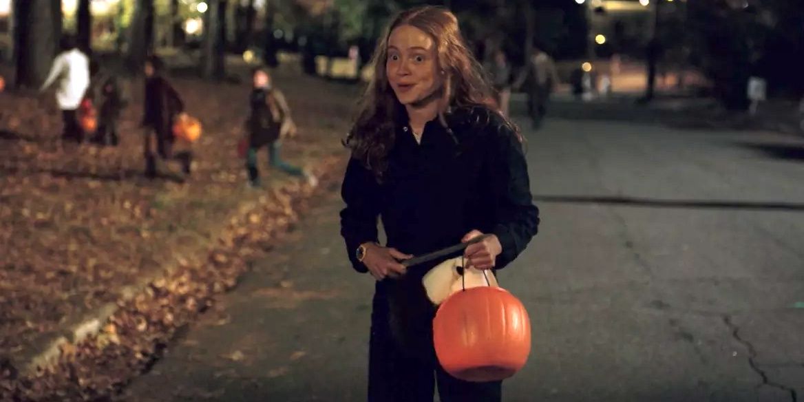 Max holding a plastic pumpkin in Stranger Things