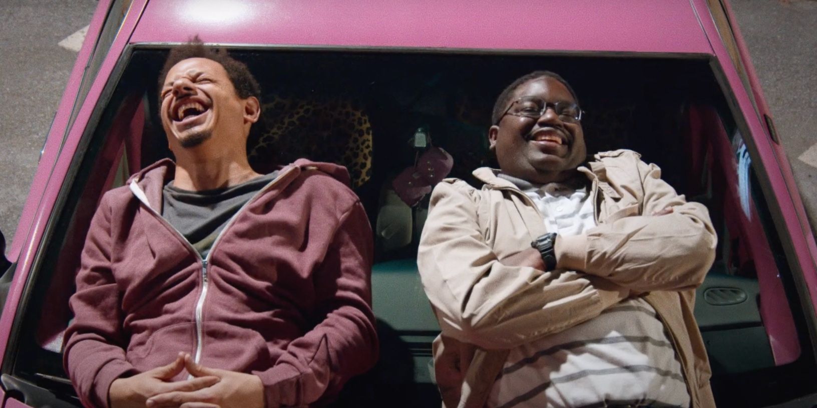 Chris and Bud laugh on the hood of their car in Bad Trip on Netflix