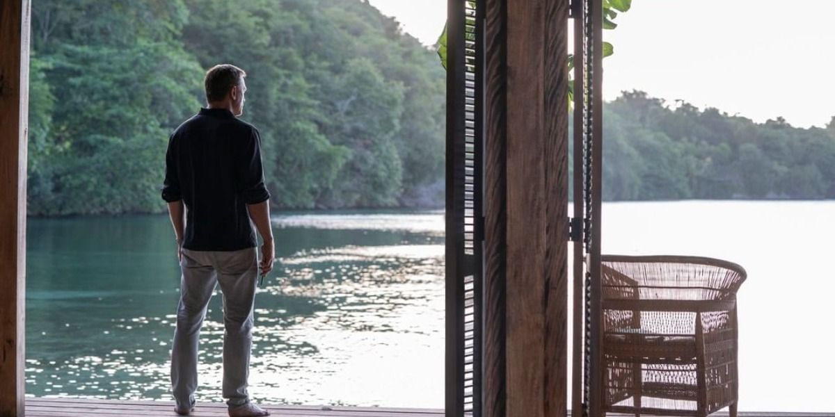 James Bond looking out on the water from his Jamaica house in No Time to Die