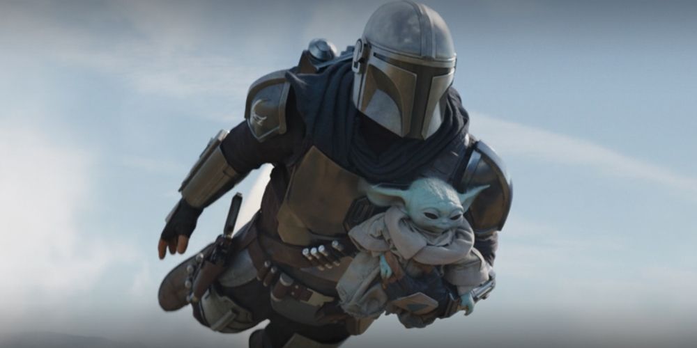 Pedro Pascal using jetpack with Grogu in The Mandalorian