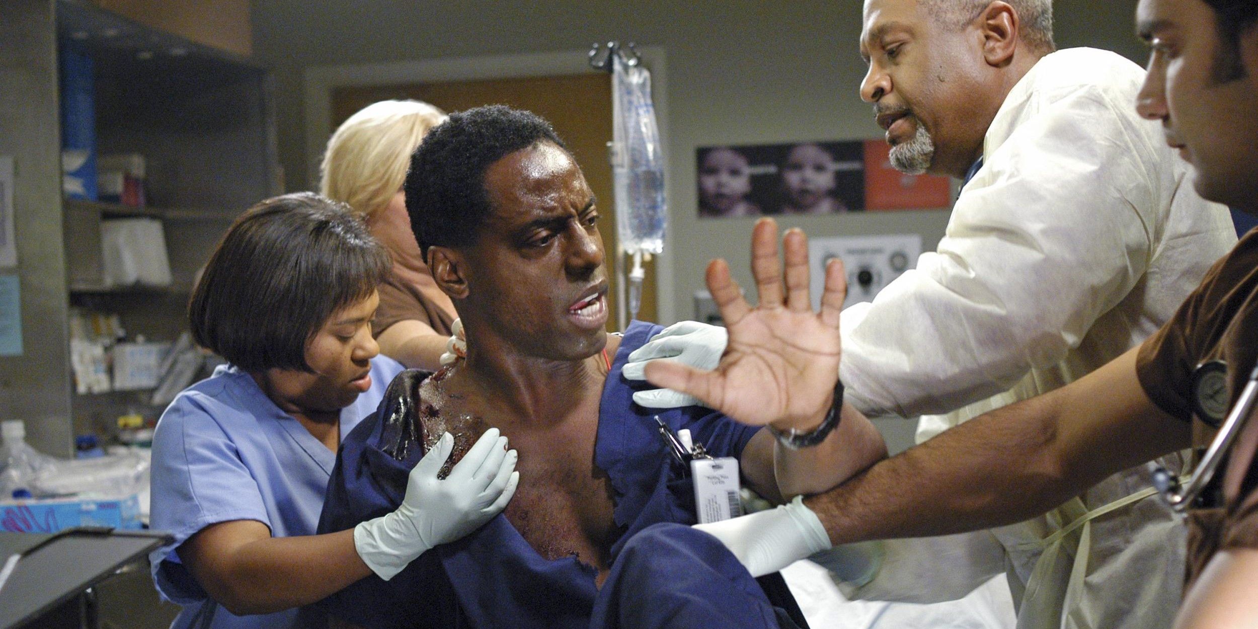 Burke resists getting treated after being shot outside the hospital in Grey's Anatomy