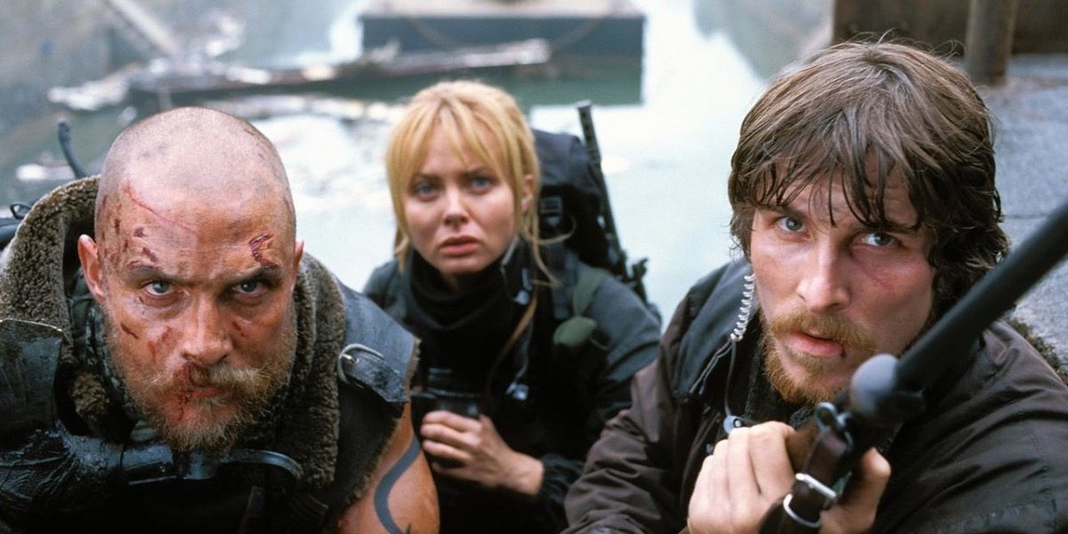 Matthew McConaughey, Christian Bale and Izabella Scorupco huddled together in Reign of Fire