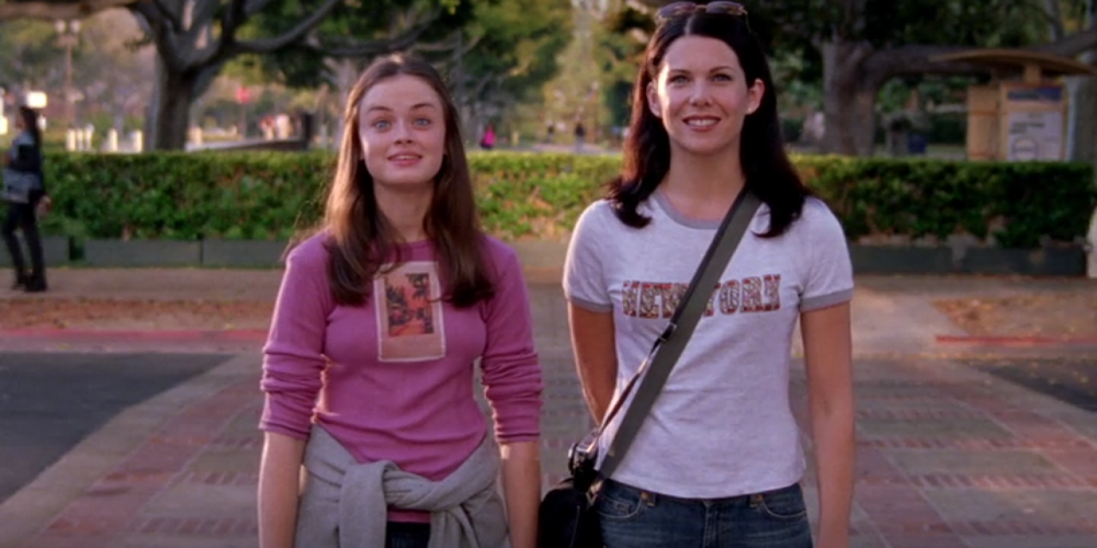 Rory with Lorelai on Harvard campus grounds, looking excited