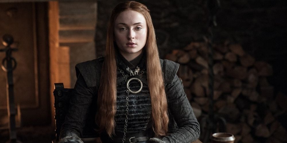Sansa Stark sitting down and looking serious in Game Of Thrones