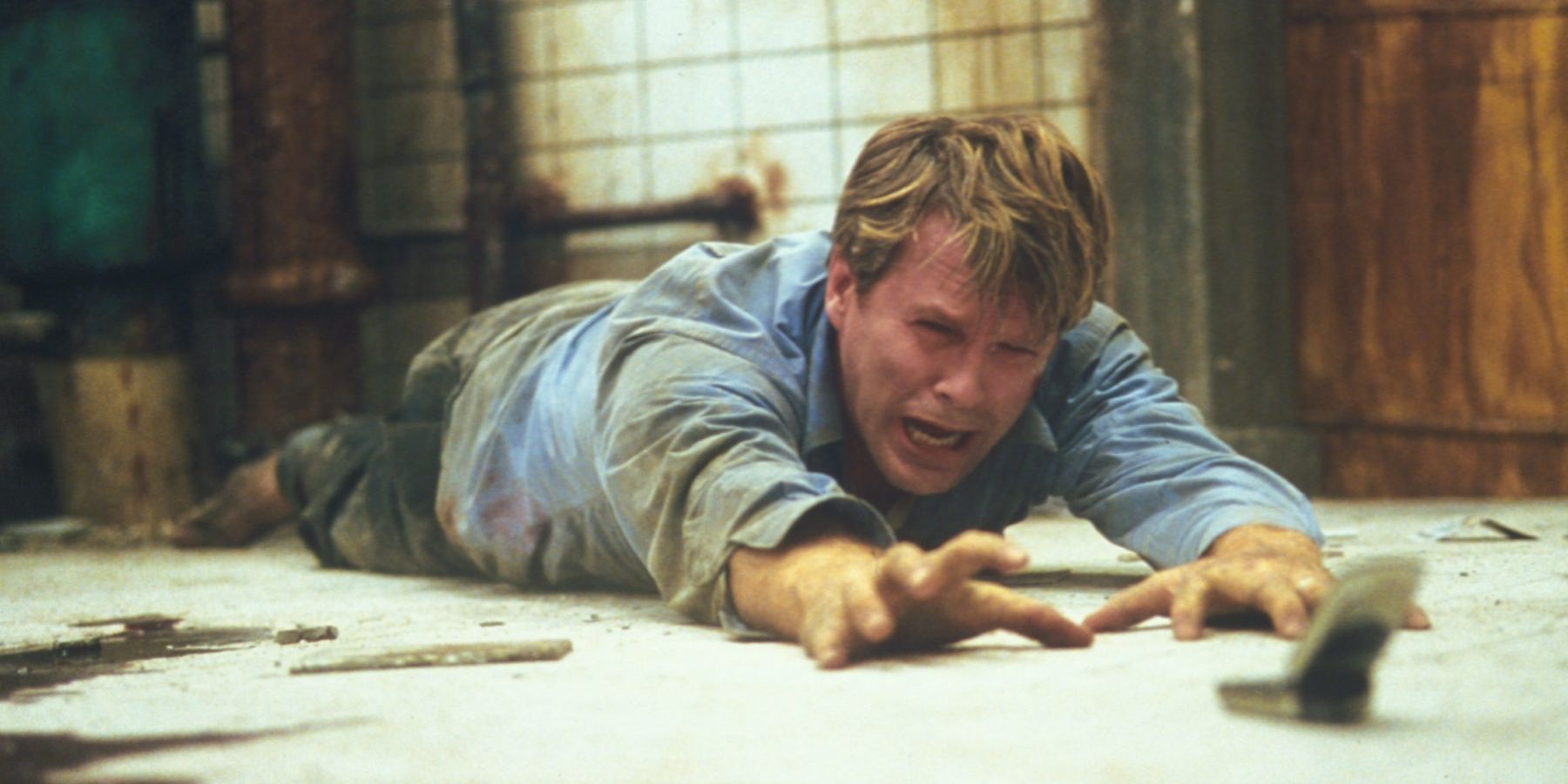 Cary Elwes reaching for the saw in Saw