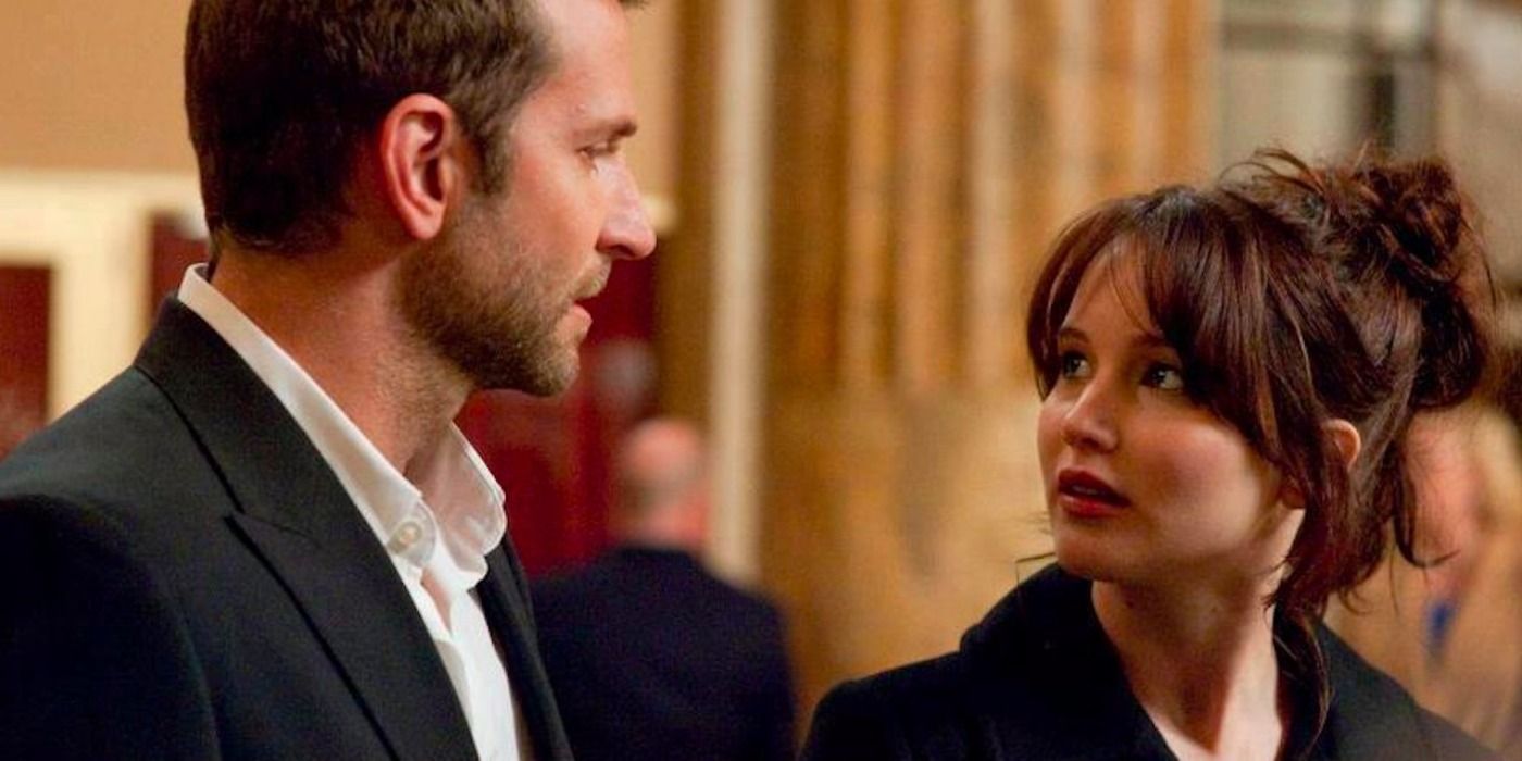 Jennifer Lawrence and Bradley Cooper look at each other at a party in Silver Linings Playbook