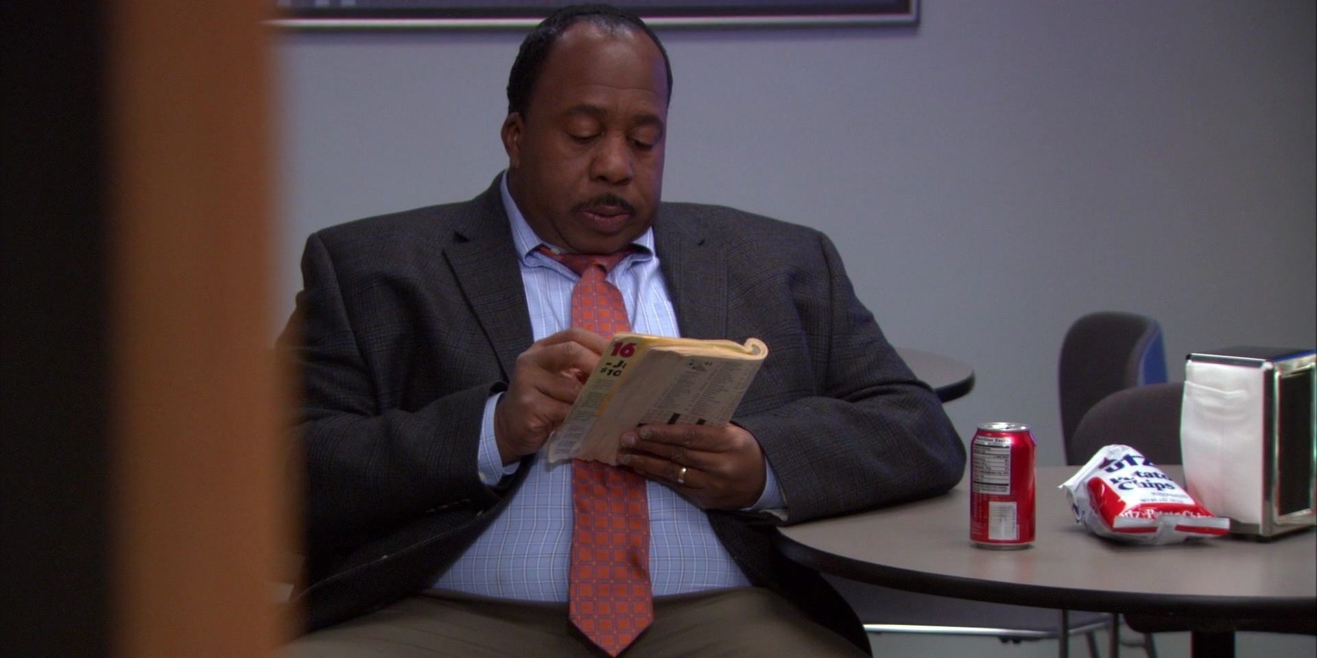 Stanley Hudson doing a crossword puzzle on The Office