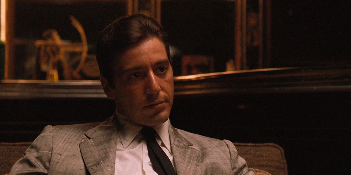 Michael Corleone sitting down and looking serious in The Godfather Part II