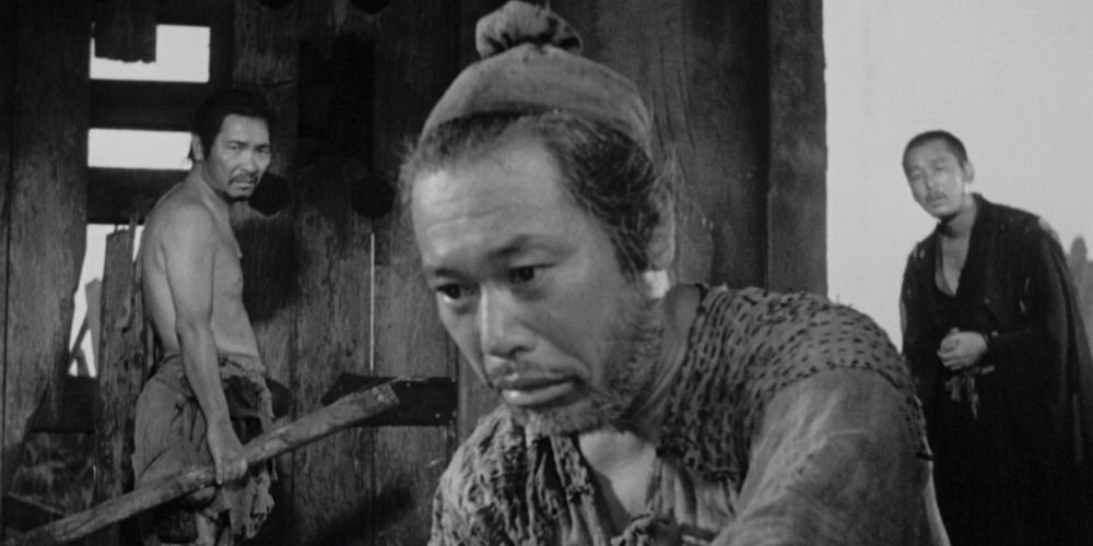The Narrators In Rashomon stand side by side and look solemn.
