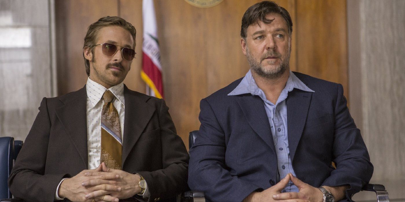 Ryan Gosling and Russell Crowe sit at a desk in The Nice Guys