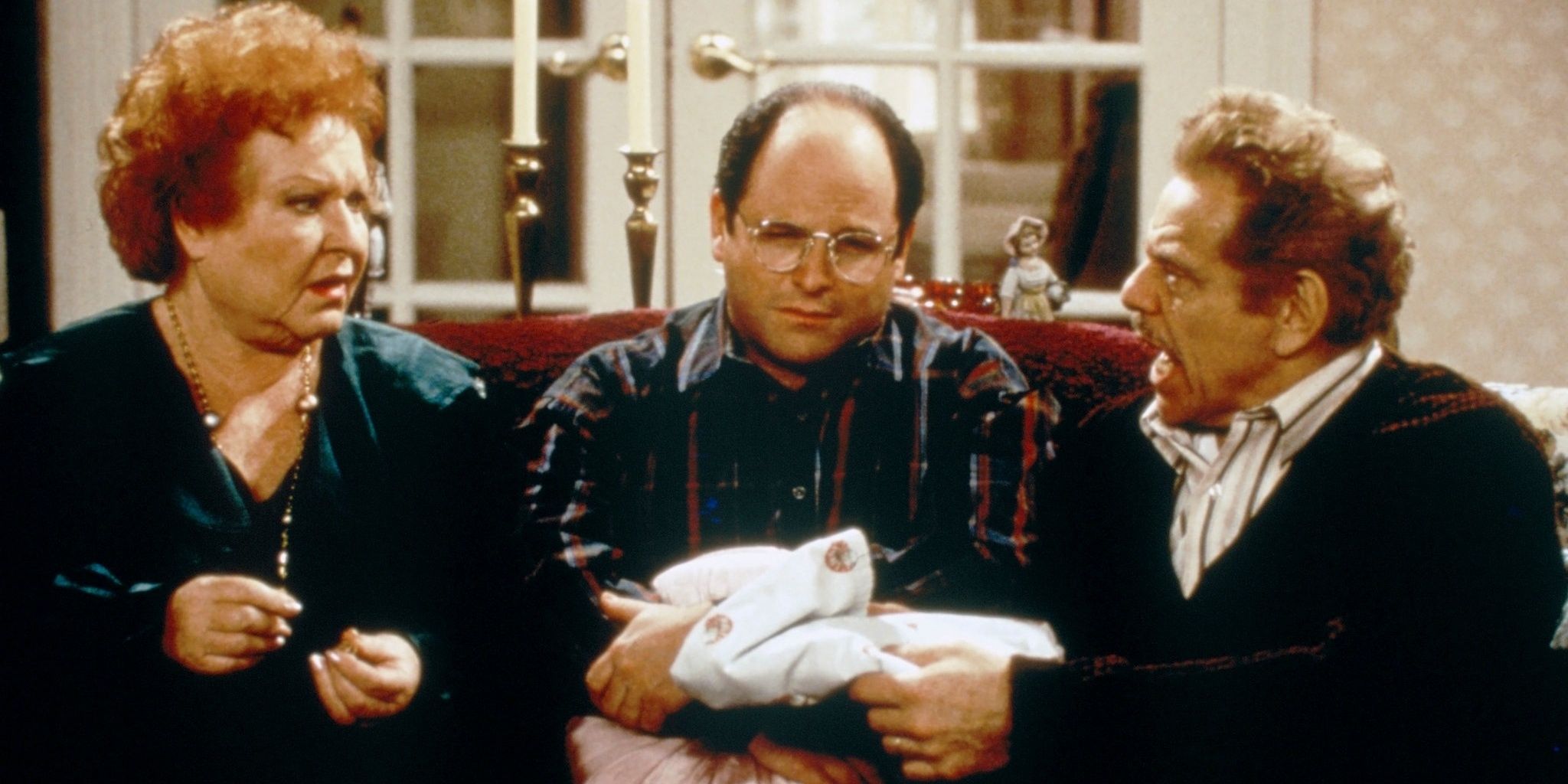 Estelle, George, and Frank sitting on the couch on Seinfeld