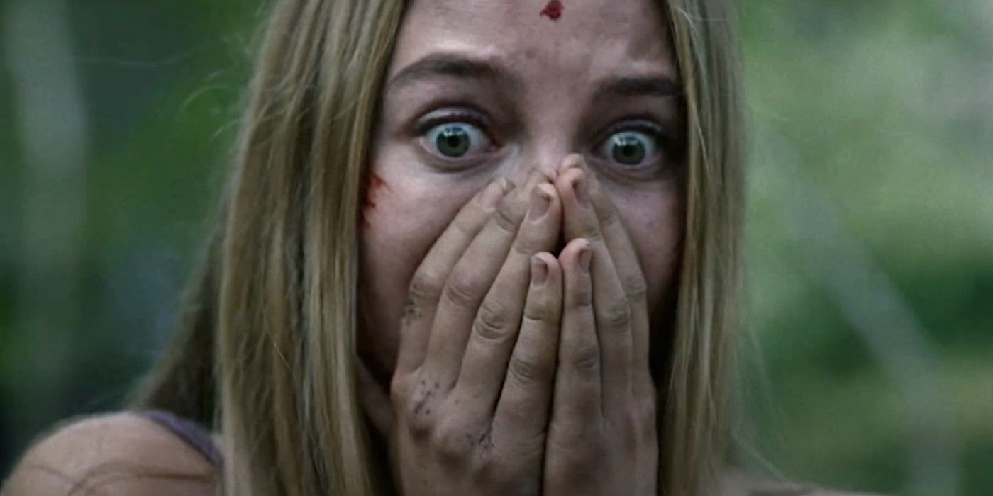 Jen covering her mouth in horror in Wrong Turn 2021 reboot.