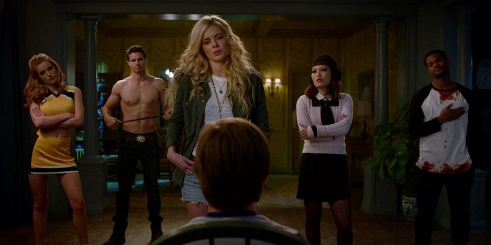 Samara Weaving, Bella Thorne, Robbie Amell and other teens look at a kid in The Babysitter