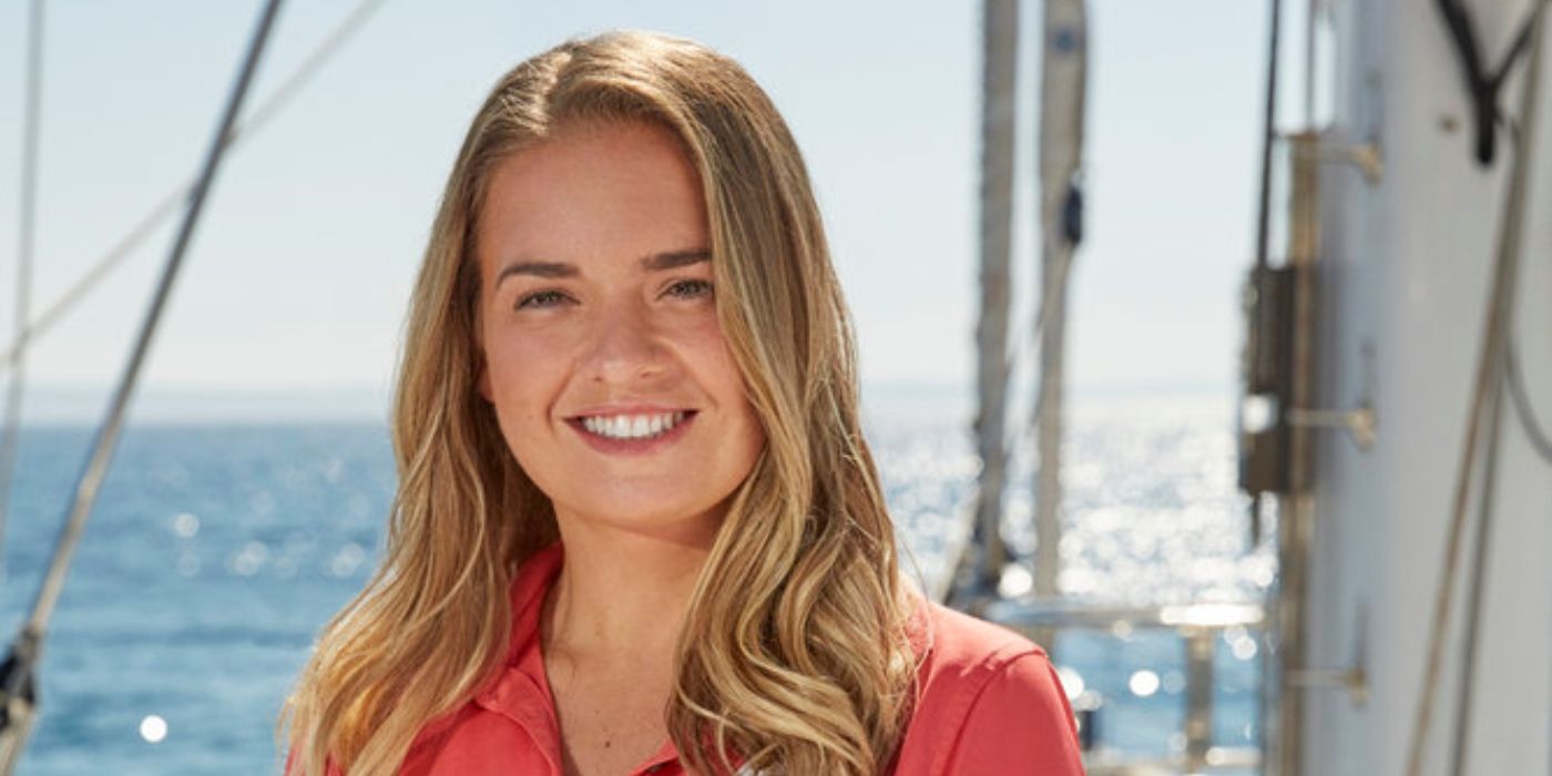Below Deck Sailing Yacht's Daisy Kelliher smiling on a yacht