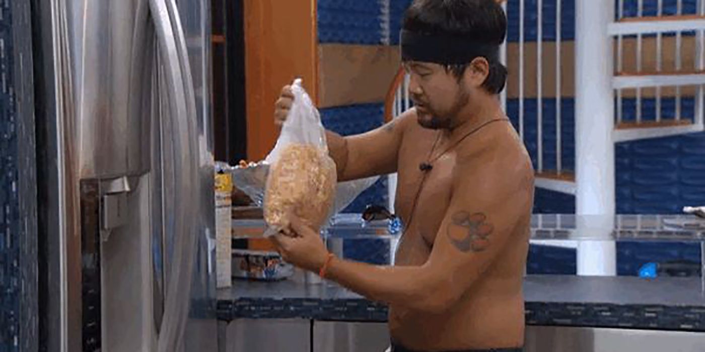 James from Big Brother tossing cereal out of bag during the Hide &amp; Go Veto competition. He isn't wearing a shirt but has a headband on