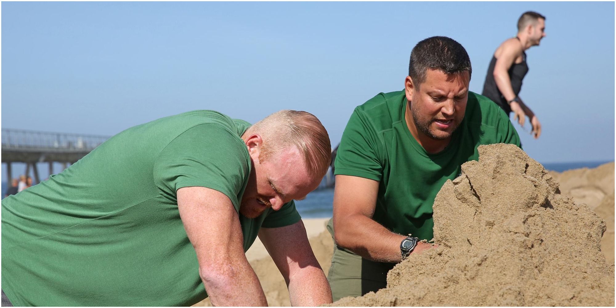 chris hammons and bret labelle with their hands on the sand