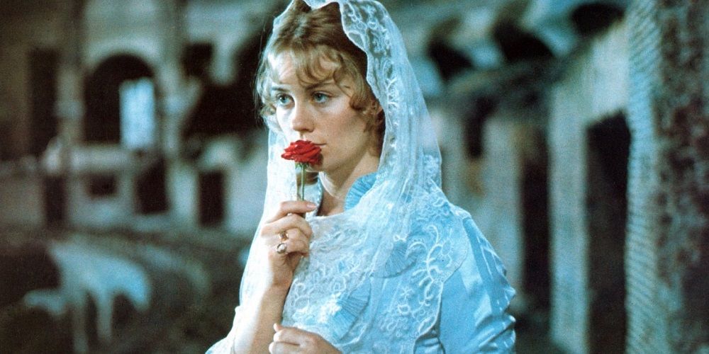 Daisy Miller holding a rose against her lips