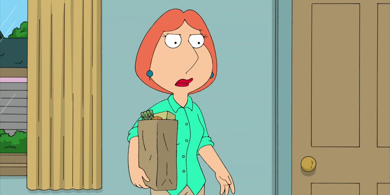 Lois stands in her house holding a bag of groceries