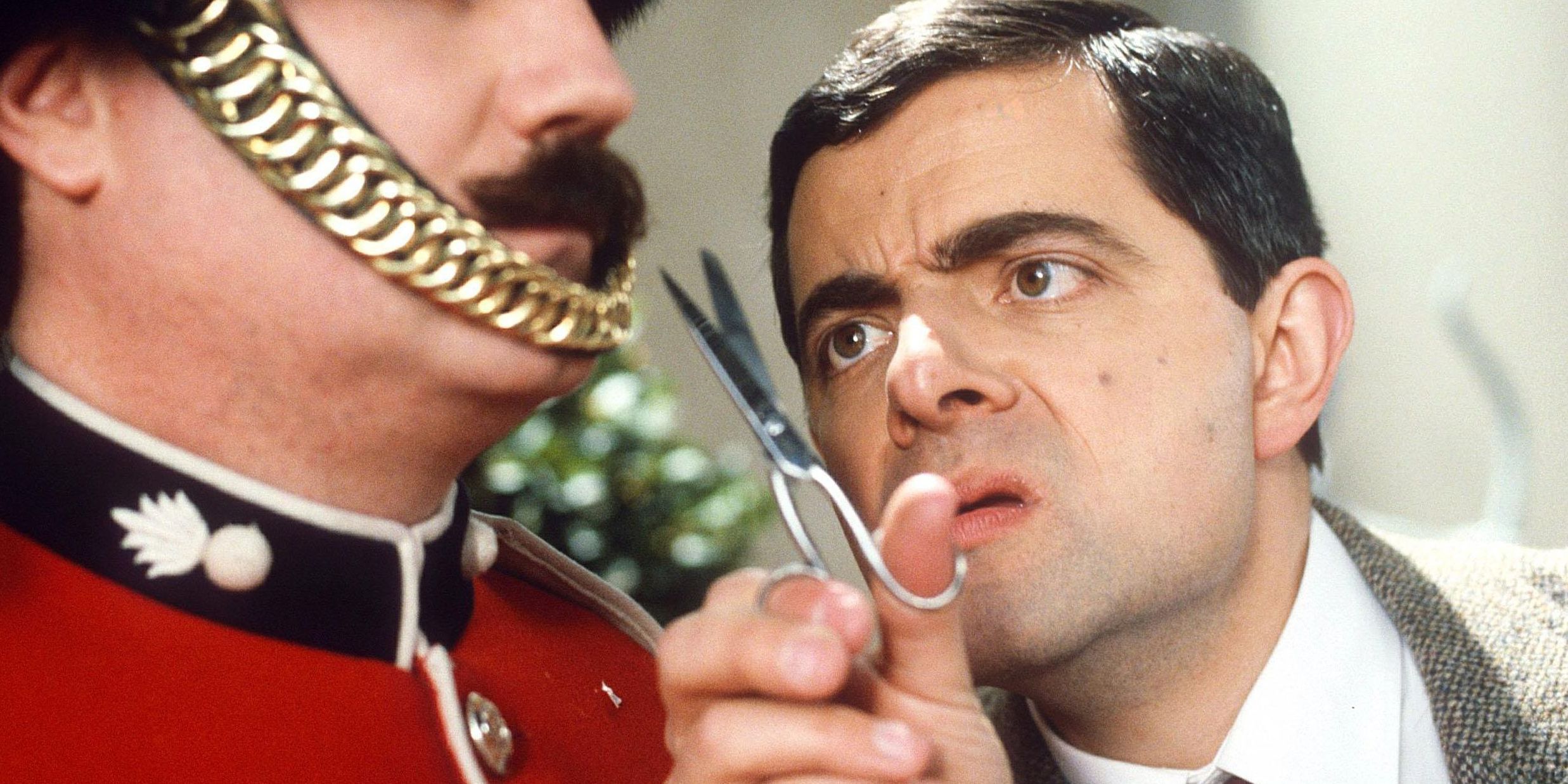 Mr. Bean trims a guard's mustache in Bean.