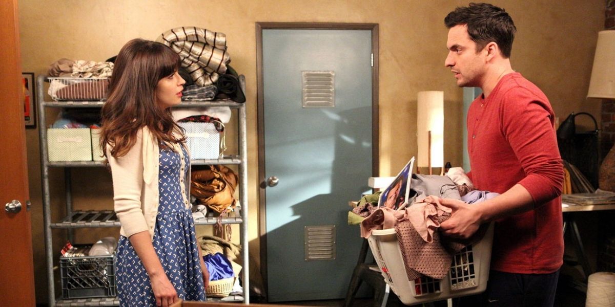 Nick and Jess having a conversation as he holds a full laundry basket in New Girl