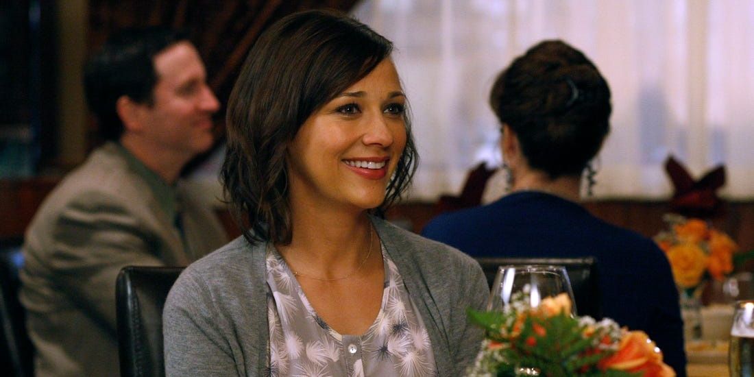 Ann Perkins smiles at dinner in Parks and Recreation
