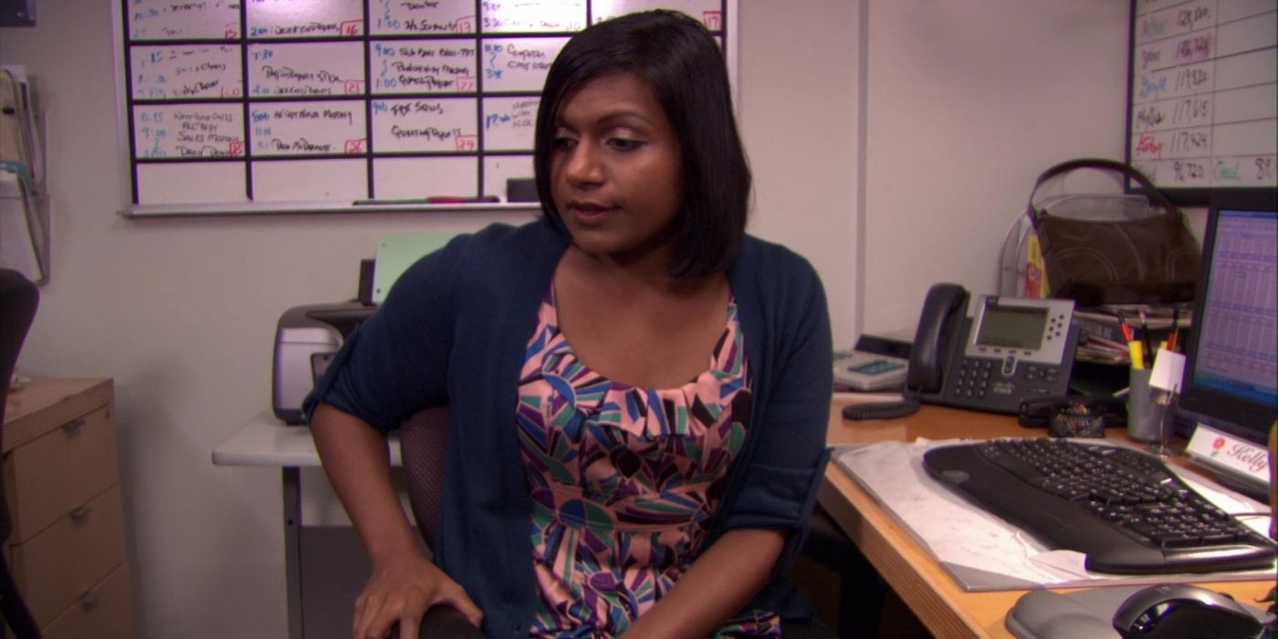 Kelly Kapoor stits at her desk on The Office.