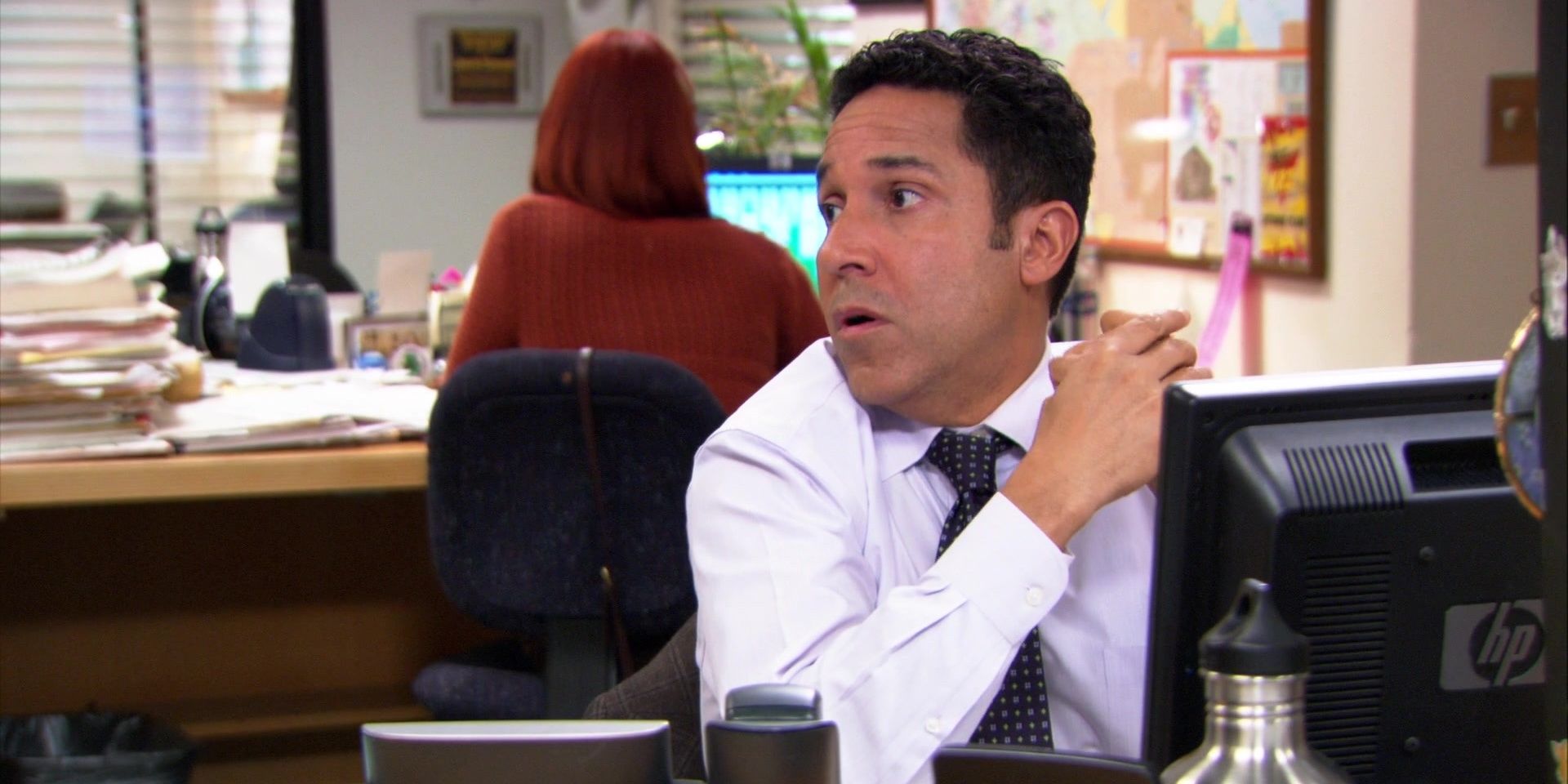 Oscar and Meredith at their desks on The Office