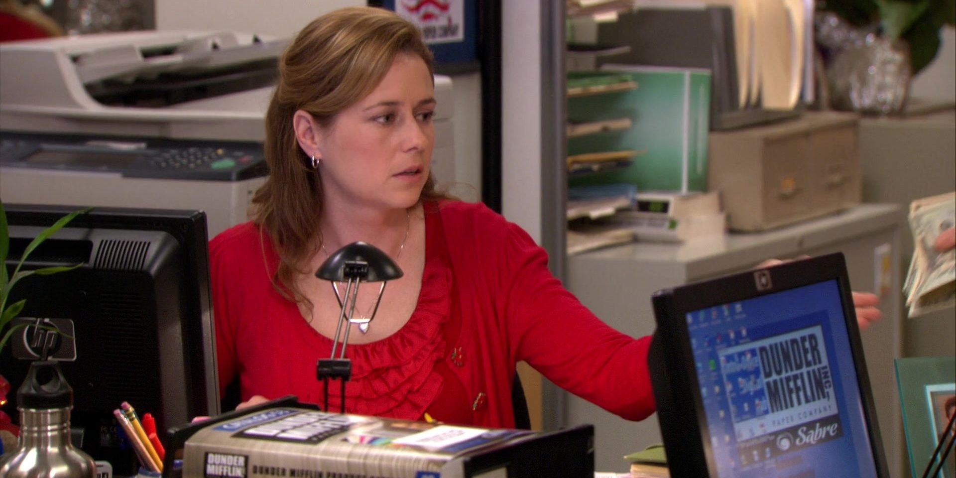 An image of Pam Beesly doing work at her desk in The Office