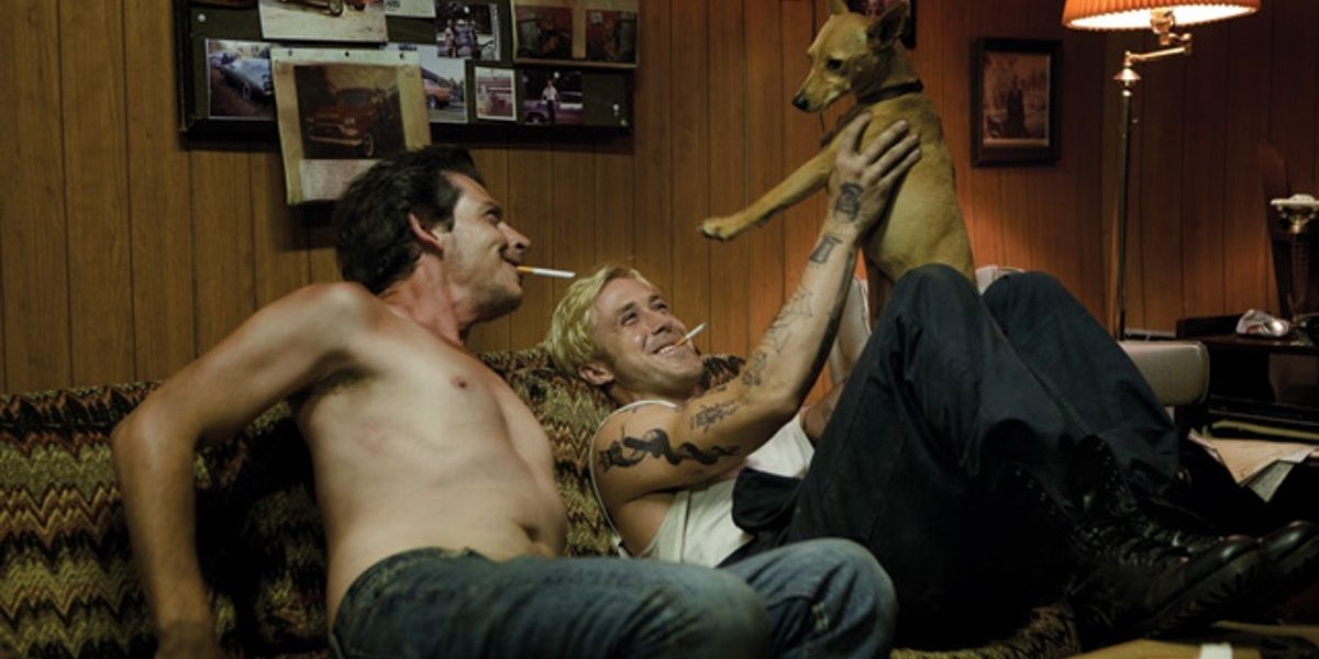 Luke and Robin play with a dog in The Place Beyond The Pines
