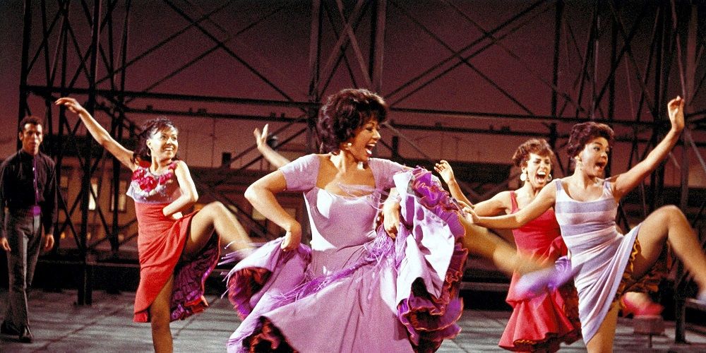 Girls in pink and red dresses dance in West Side Story 1961