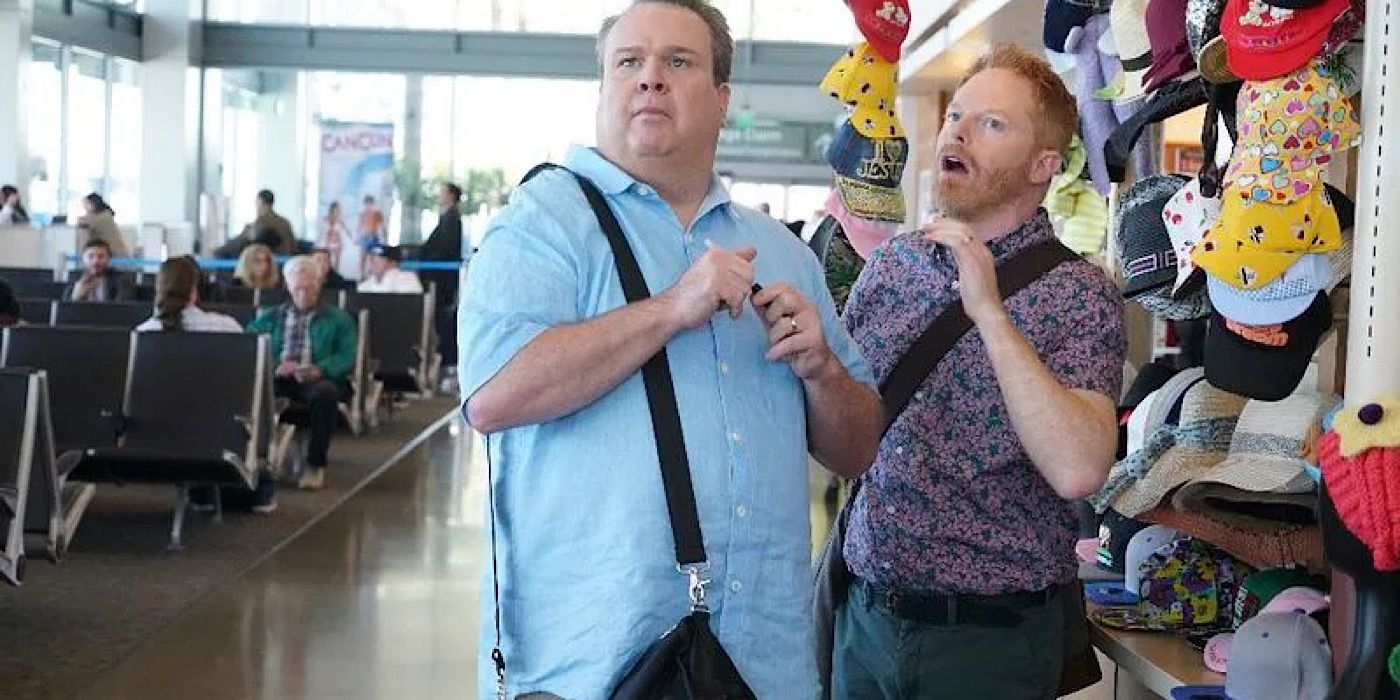 Cam and Mitch at the airport in Modern Family