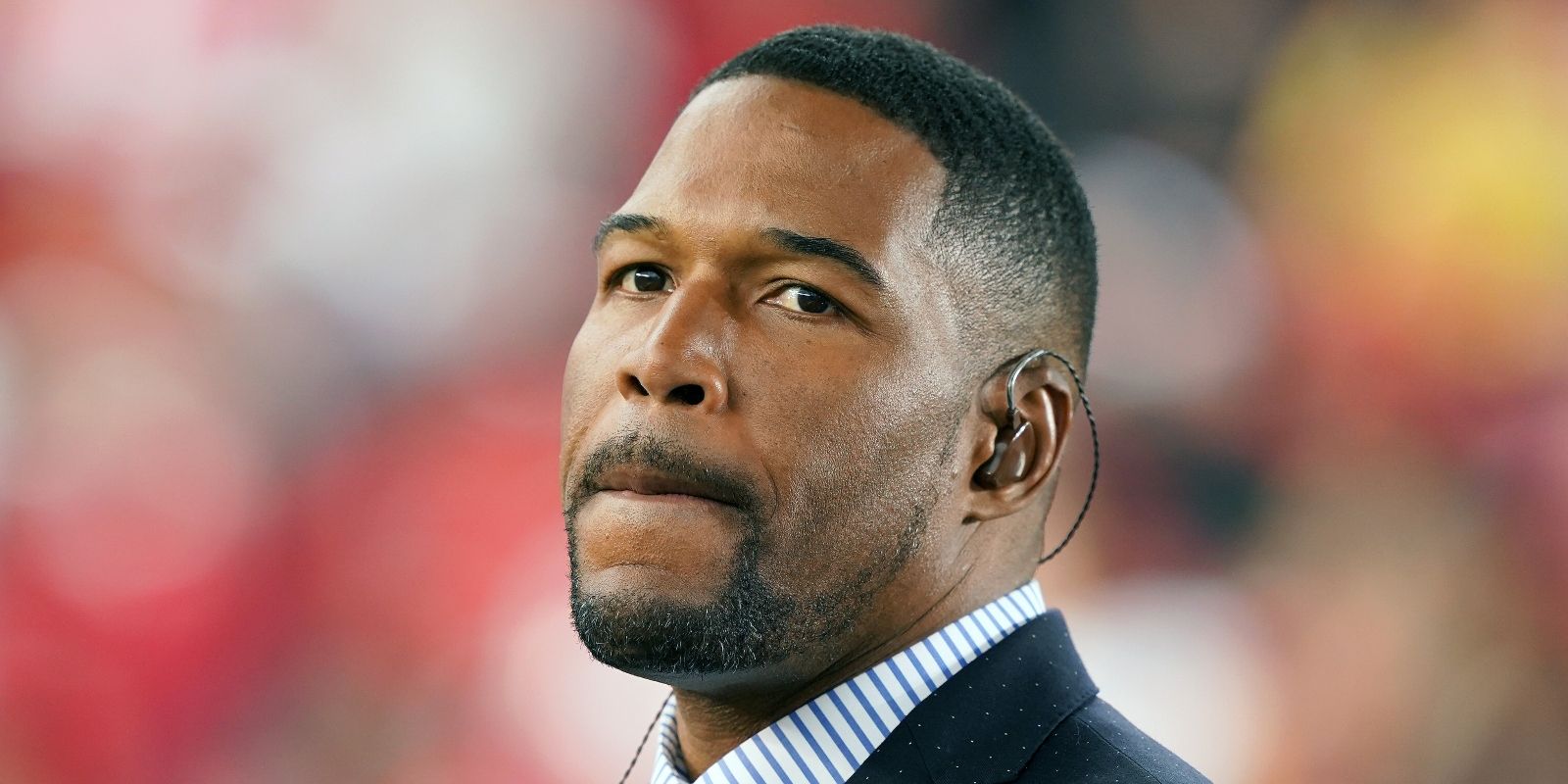 Michael Strahan in a football field.