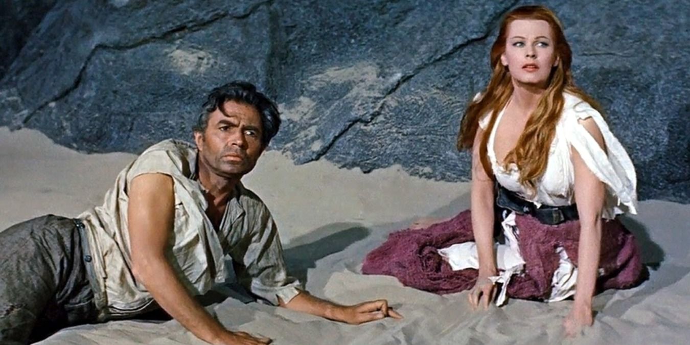 James Mason and Arlene Dahl sitting on the sand in Journey To The Center Of The Earth