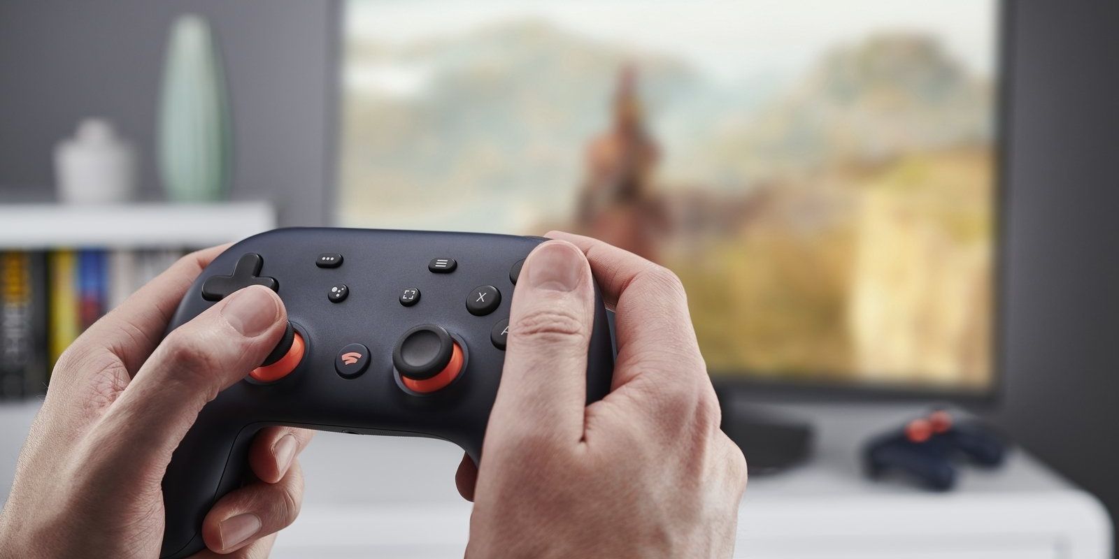 A man using the google Stadia controller