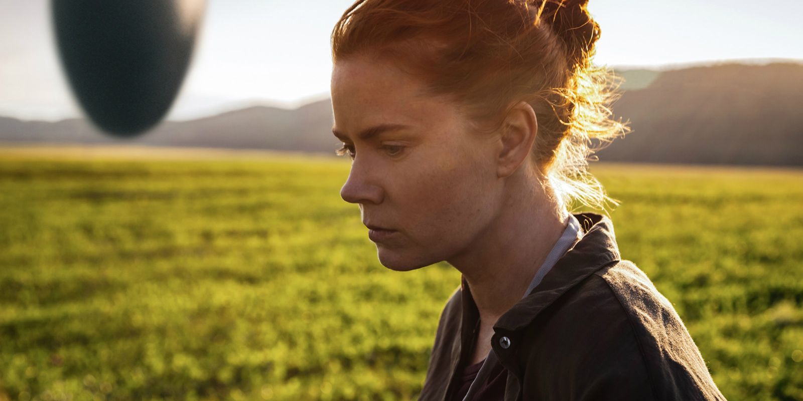 Amy Adams looking on in the movie Arrival.