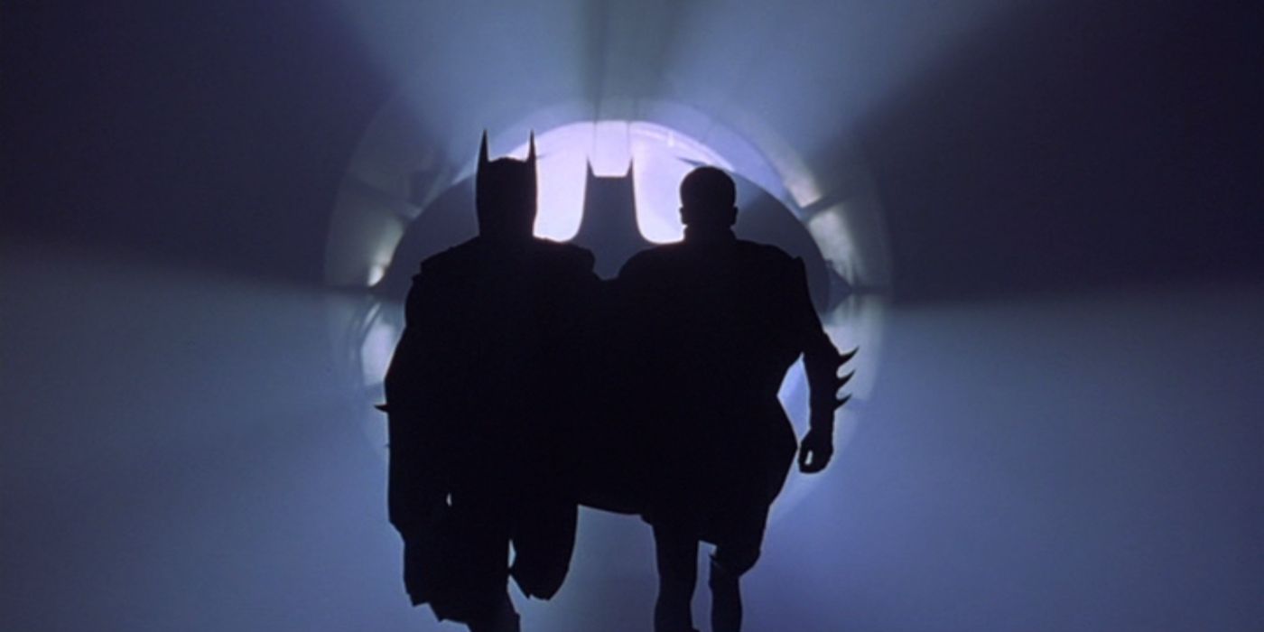 Silhouetted Batman and Robin running toward camera in Batman Forever