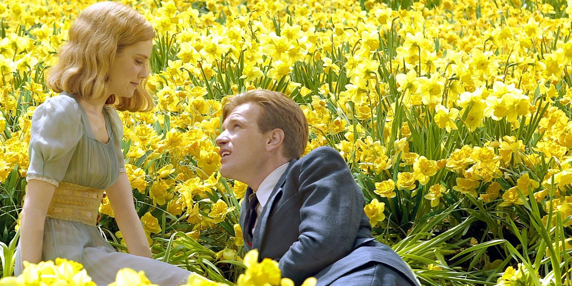 A man and a woman (Alison Lohman and Ewan McGregor) sitting in a field of yellow flowers in Big Fish